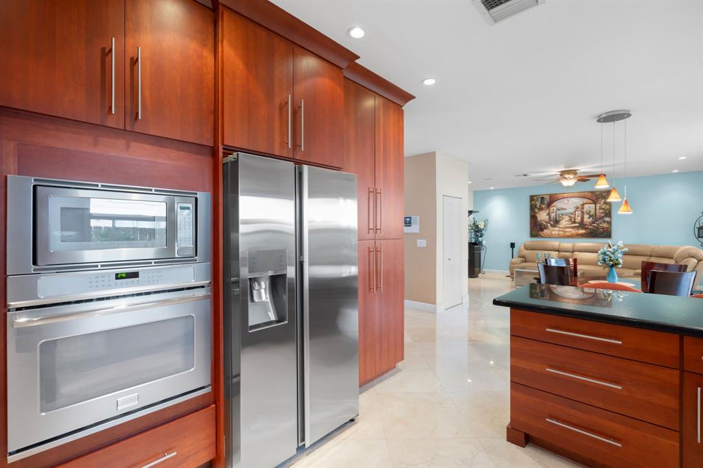 15256 Southwest 108th Terrace Miami, FL 33196 - Photo 11 of 40 a kitchen with stainless steel appliances a refrigerator and a stove
