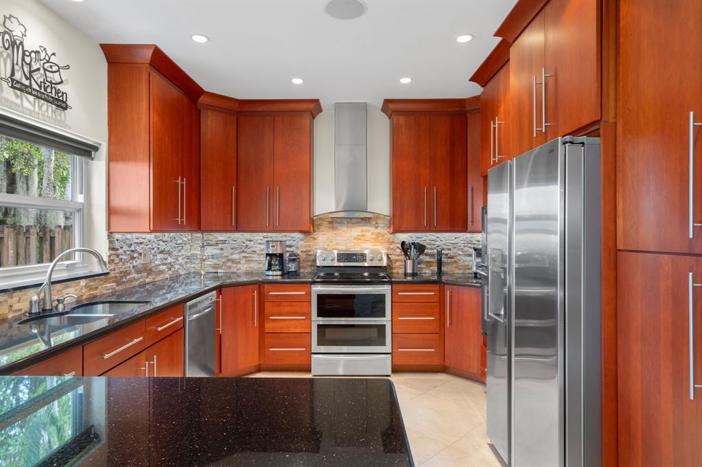 15256 Southwest 108th Terrace Miami, FL 33196 - Photo 12 of 40 a kitchen with stainless steel appliances granite countertop a refrigerator and a sink