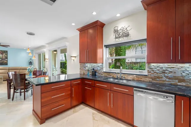 a kitchen with a sink stove and cabinets