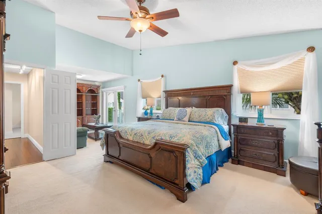 a bedroom with a large bed and a chandelier