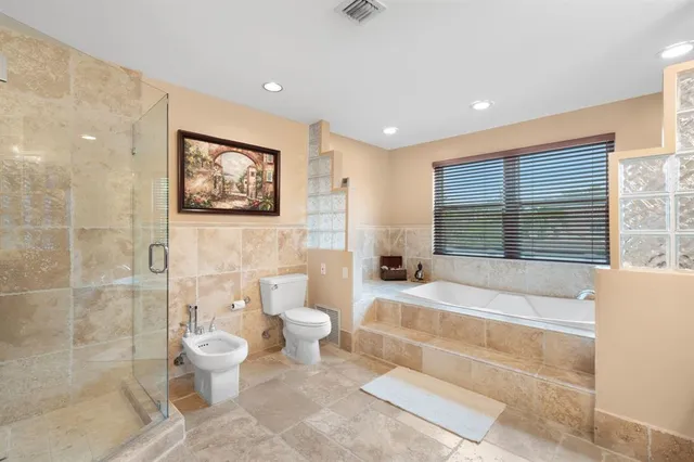a spacious bathroom with a bathtub and a toilet