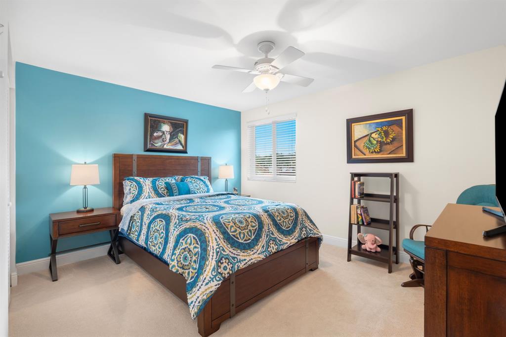 15256 Southwest 108th Terrace Miami, FL 33196 - Photo 28 of 40 a bedroom with a bed and a chandelier