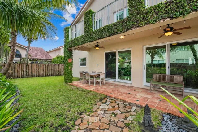 a view of a house with backyard porch and sitting area