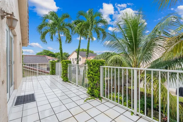 a view of balcony with a palm trees