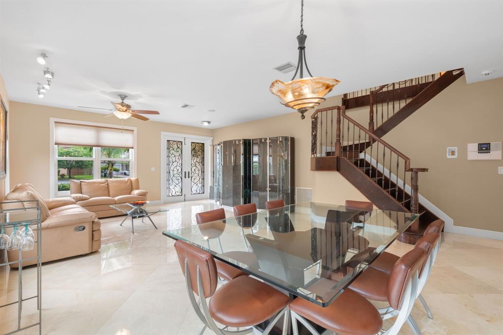 15256 Southwest 108th Terrace Miami, FL 33196 - Photo 4 of 40 a dining room with furniture a chandelier and wooden floor