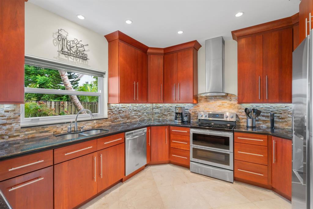 15256 Southwest 108th Terrace Miami, FL 33196 - Photo 9 of 40 a kitchen with stainless steel appliances granite countertop a stove a sink and a microwave