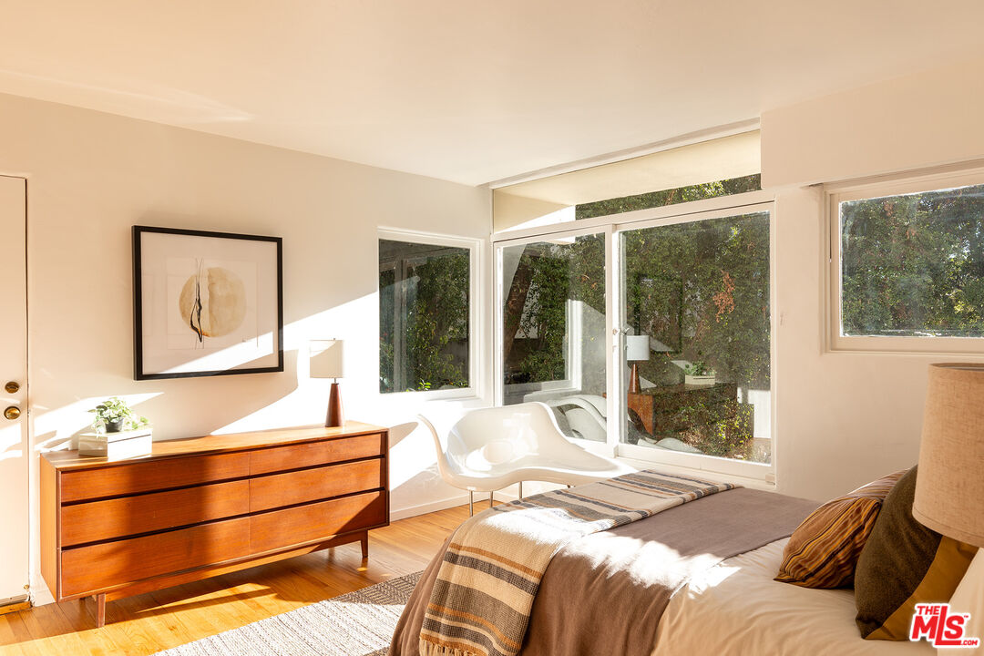 2764 Outpost Drive Los Angeles, CA 90068 - Photo 15 of 37 a bedroom with a bed and wooden floor