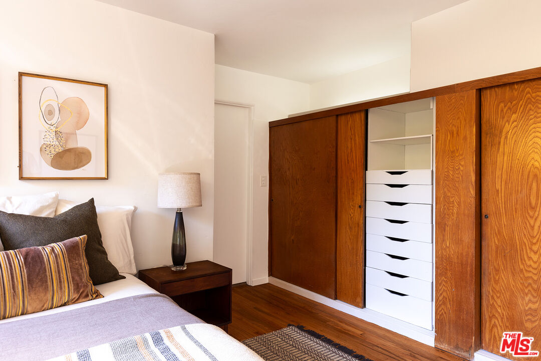 2764 Outpost Drive Los Angeles, CA 90068 - Photo 16 of 37 a bedroom with a bed and a lamp with the wooden floor
