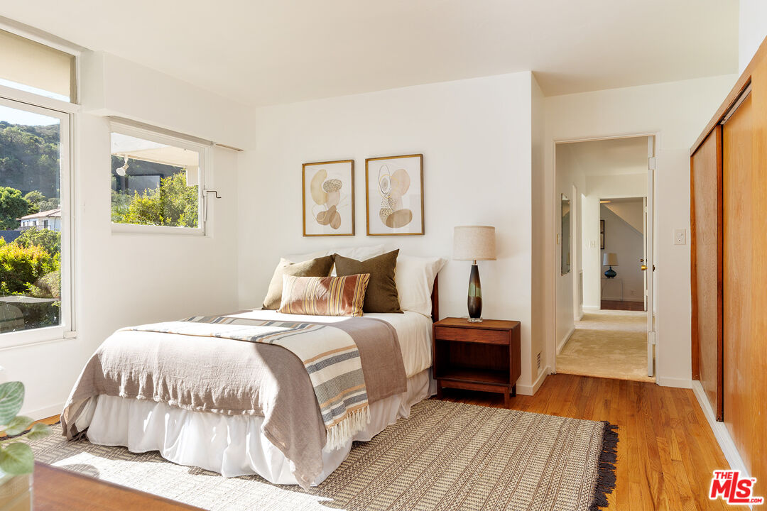 2764 Outpost Drive Los Angeles, CA 90068 - Photo 17 of 37 a bedroom with a bed and a painting on the wall