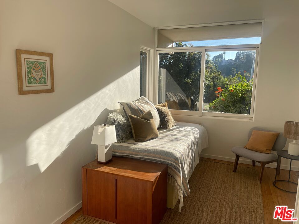 2764 Outpost Drive Los Angeles, CA 90068 - Photo 19 of 37 a bed sitting in a bedroom next to a window