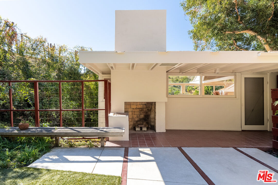 2764 Outpost Drive Los Angeles, CA 90068 - Photo 23 of 37 a view of a patio with table and chairs with wooden floor and fence