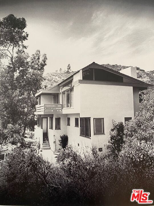 2764 Outpost Drive Los Angeles, CA 90068 - Photo 28 of 37 a front view of a house with a garden