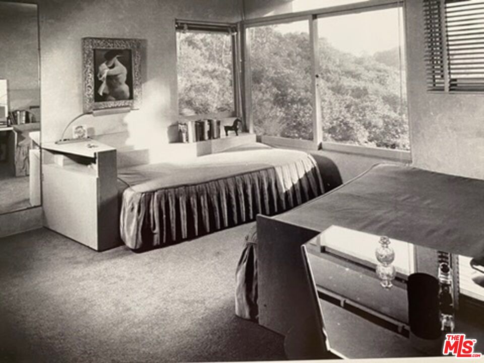 2764 Outpost Drive Los Angeles, CA 90068 - Photo 35 of 37 a bedroom with two beds and large windows