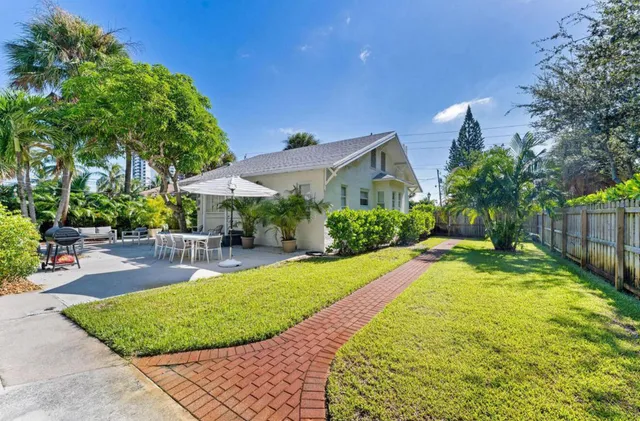 a view of a backyard with plants and patio