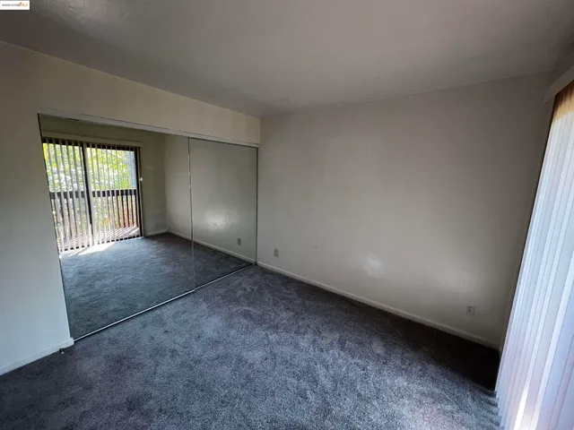 an empty room with a empty space and windows