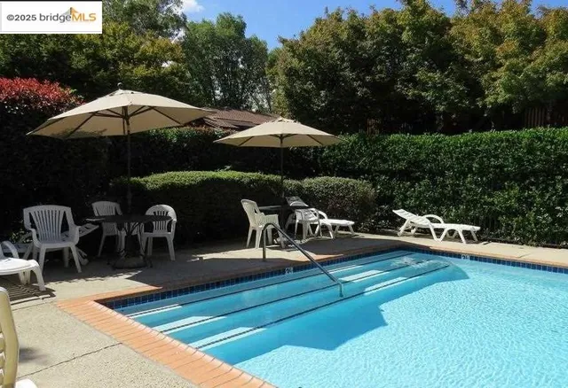a view of a backyard with sitting area and furniture