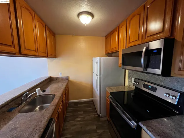 a kitchen with stainless steel appliances granite countertop a stove and a refrigerator