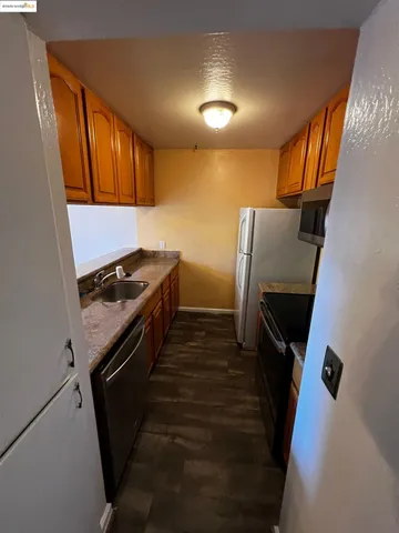 a kitchen with a sink a refrigerator and window