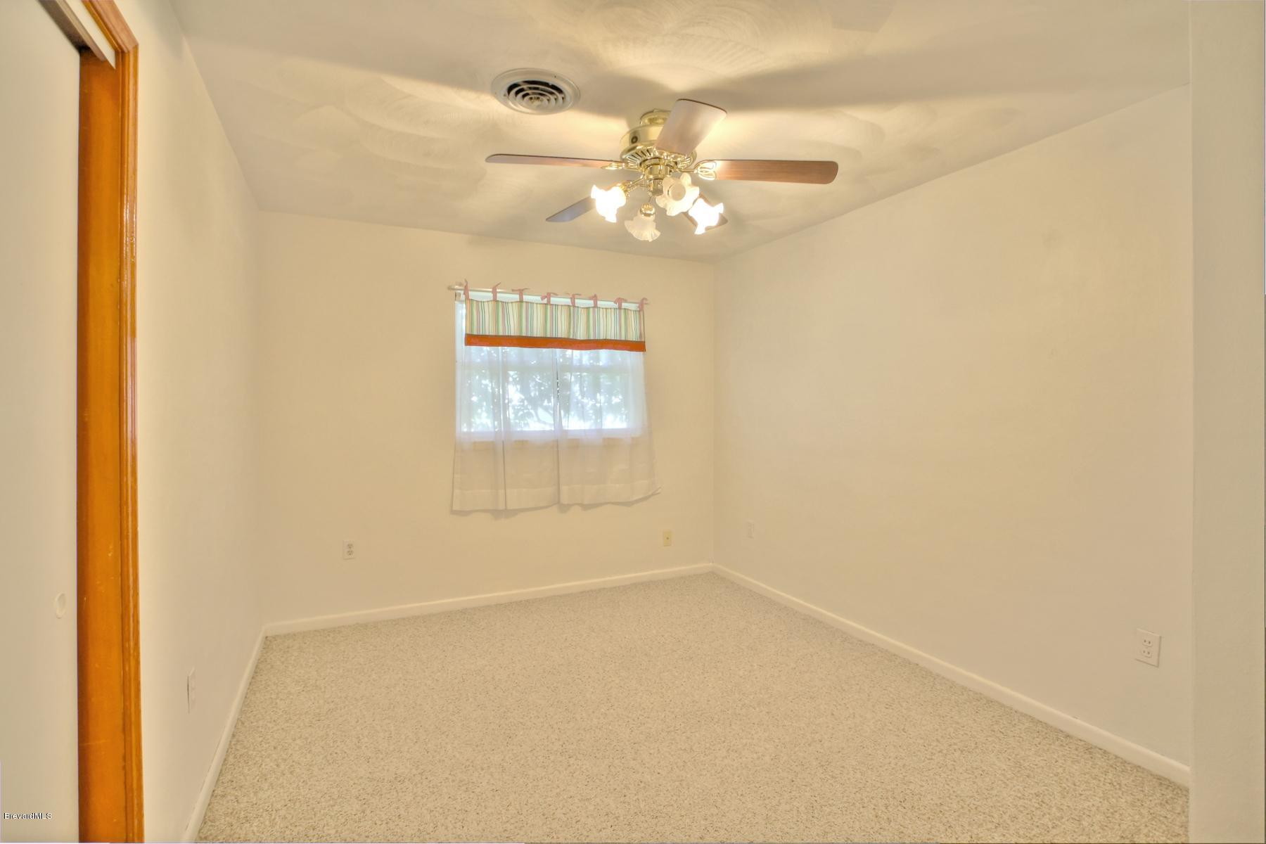 972 Sarno Road Melbourne, FL 32935 - Photo 17 of 20 Guest Bedroom with Ceiling Fan