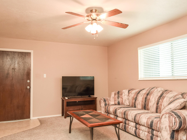 240 East 400 North, Unit 26 Logan, UT 84321 - Photo 3 of 10 Carpeted living area featuring ceiling fan and baseboards