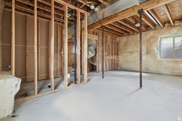 20 Q Puma Road Fairview, UT 84629 - Photo 23 of 27 Unfinished basement featuring wood framing, exposed joists, concrete flooring, and a visible window opening