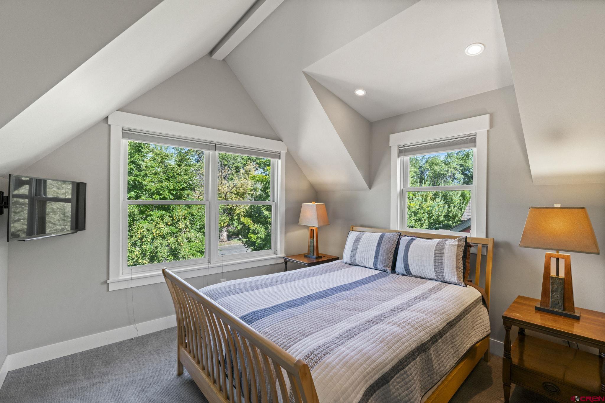714 East 5th Avenue Durango, CO 81301 - Photo 27 of 35 a bedroom with a bed and a lamp next to a window