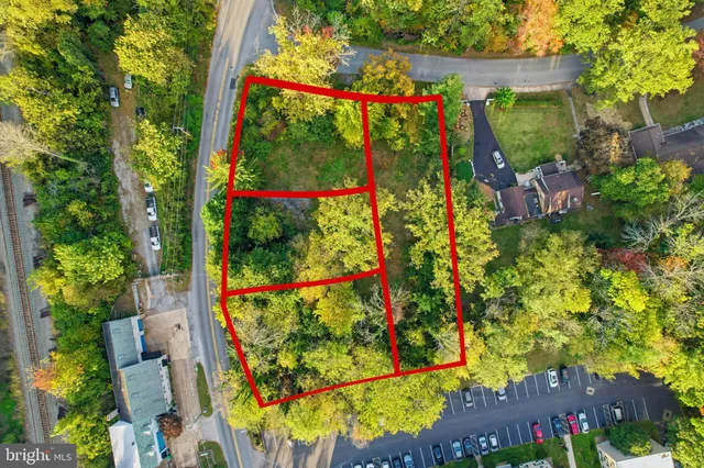 an aerial view of a residential houses with yard