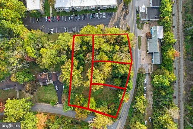 an aerial view of a residential houses with yard