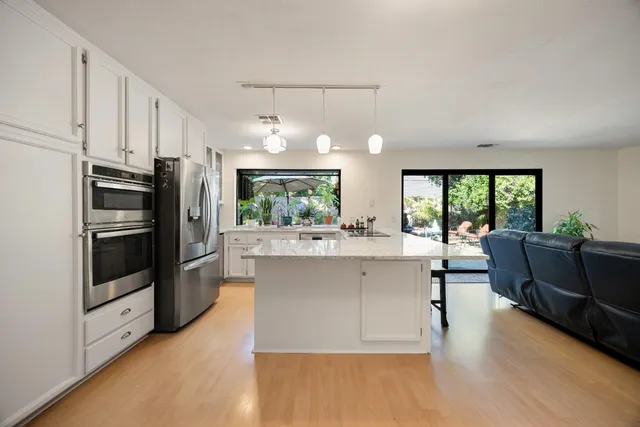 a kitchen with counter top space and stainless steel appliances