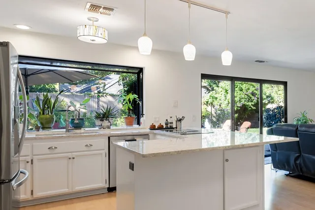 a room with a large window and a chandelier