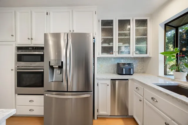 a kitchen with stainless steel appliances a refrigerator and a sink