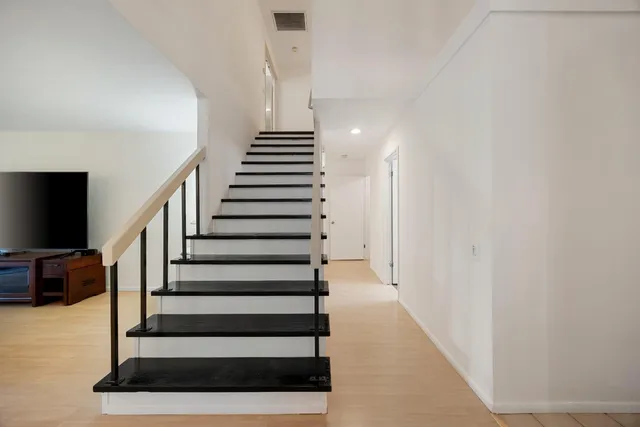 a view of entryway and hall with wooden floor
