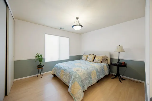 a bedroom with a bed and a table