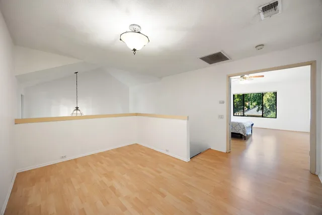 a view of a room with wooden floor and window