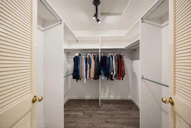 a view of walk in closet with clothes