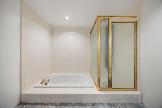 a bathroom with a bathtub and shower