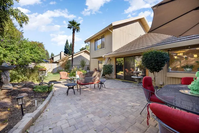 a backyard of a house with outdoor seating