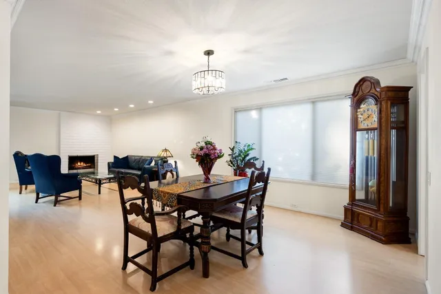 a view of a dining room with furniture and a chandelier
