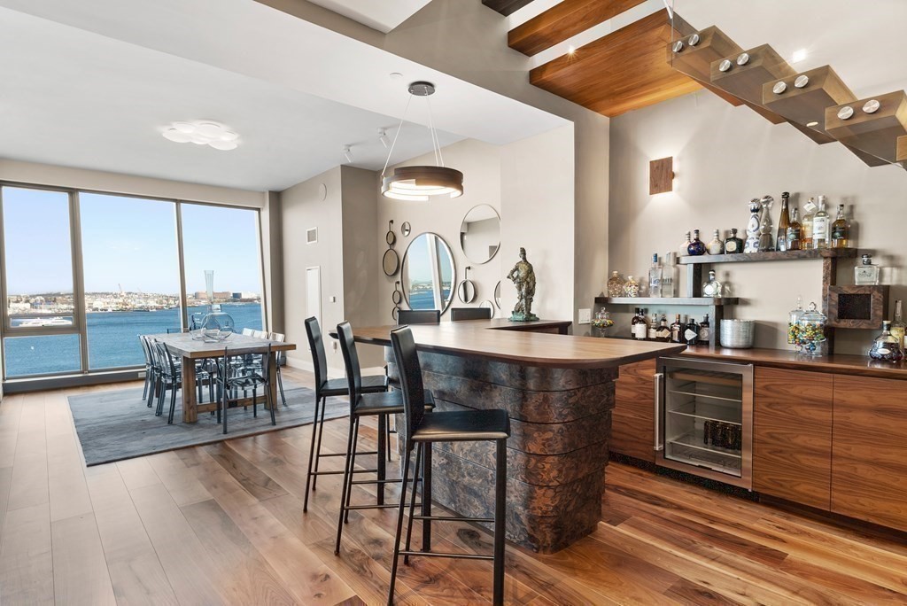 300 Pier 4 Blvd., Unit PHC Boston, MA 02210 - Photo 14 of 42 a view of a dining room with furniture window and wooden floor
