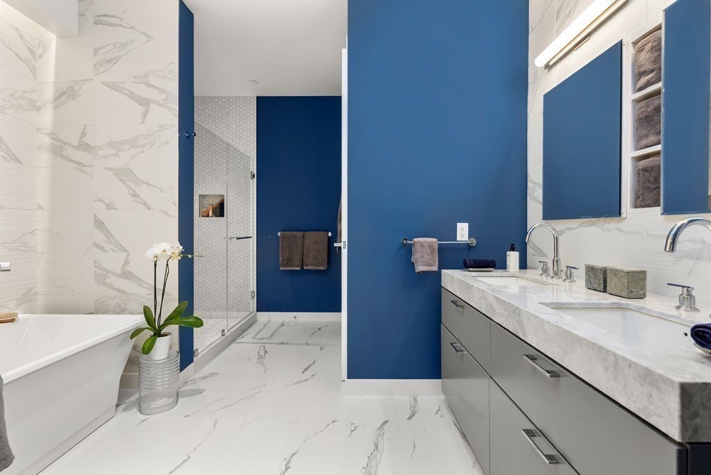 300 Pier 4 Blvd., Unit PHC Boston, MA 02210 - Photo 22 of 42 a spacious bathroom with a granite countertop tub sink and a mirror