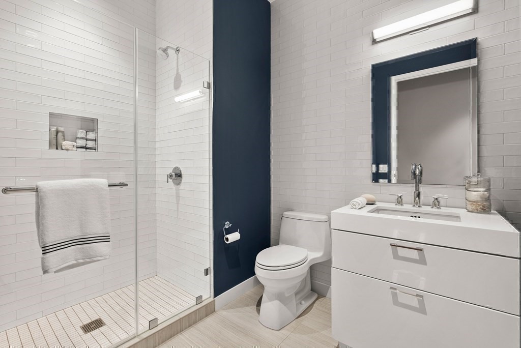 300 Pier 4 Blvd., Unit PHC Boston, MA 02210 - Photo 25 of 42 a bathroom with a toilet sink and a mirror