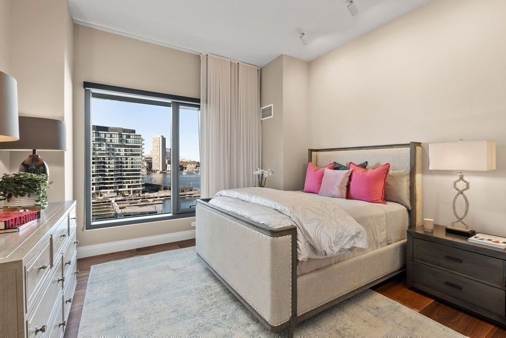 300 Pier 4 Blvd., Unit PHC Boston, MA 02210 - Photo 26 of 42 a spacious bedroom with a bed and a window
