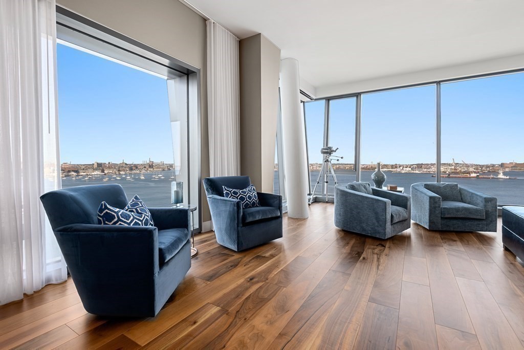 300 Pier 4 Blvd., Unit PHC Boston, MA 02210 - Photo 5 of 42 a living room with furniture floor to ceiling window and a wooden floor