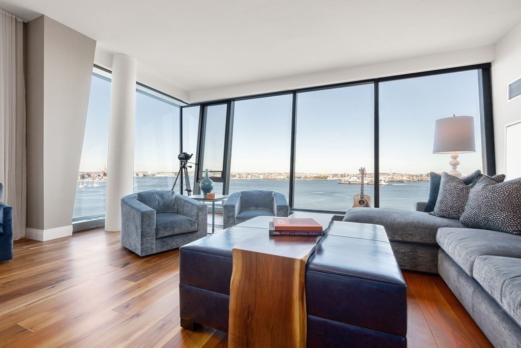300 Pier 4 Blvd., Unit PHC Boston, MA 02210 - Photo 6 of 42 a living room with furniture and large windows