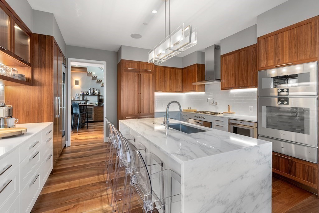 300 Pier 4 Blvd., Unit PHC Boston, MA 02210 - Photo 8 of 42 a kitchen with stainless steel appliances granite countertop a sink stove and refrigerator