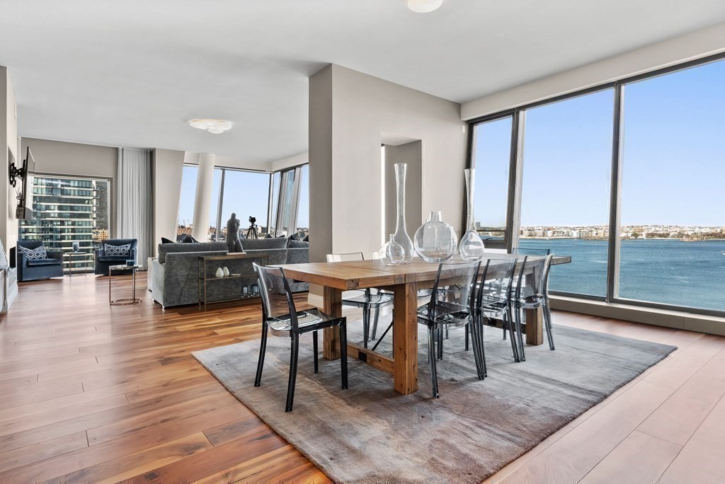 300 Pier 4 Blvd., Unit PHC Boston, MA 02210 - Photo 10 of 42 a view of a dining room with furniture and wooden floor