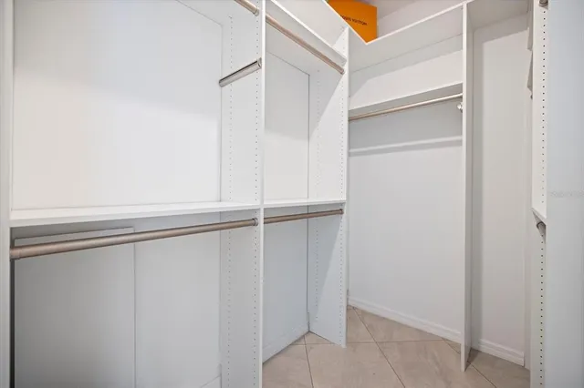 a view of walk in closet with empty racks