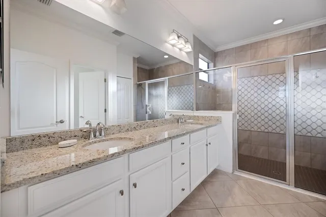 a bathroom with a granite countertop sink double and mirror