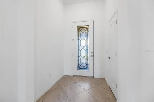 an empty room with cabinet and mirror