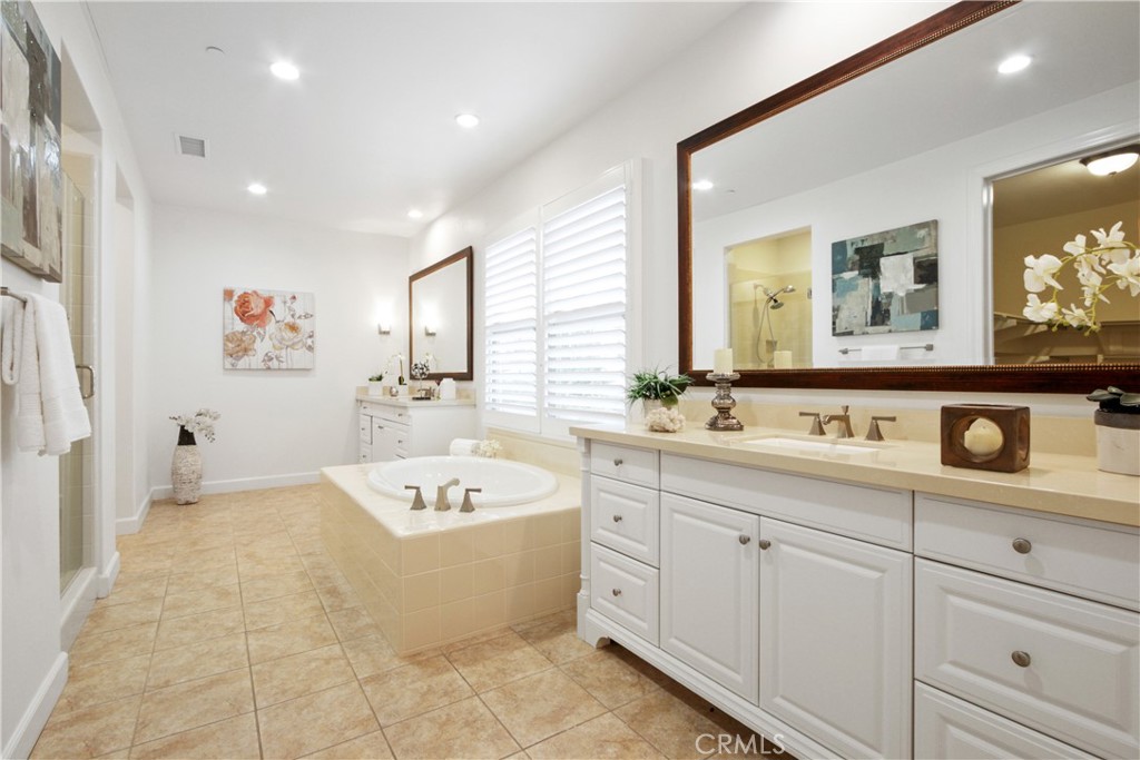 64 Hazelton Irvine, CA 92620 - Photo 14 of 23 a bathroom with a tub a sink and a mirror
